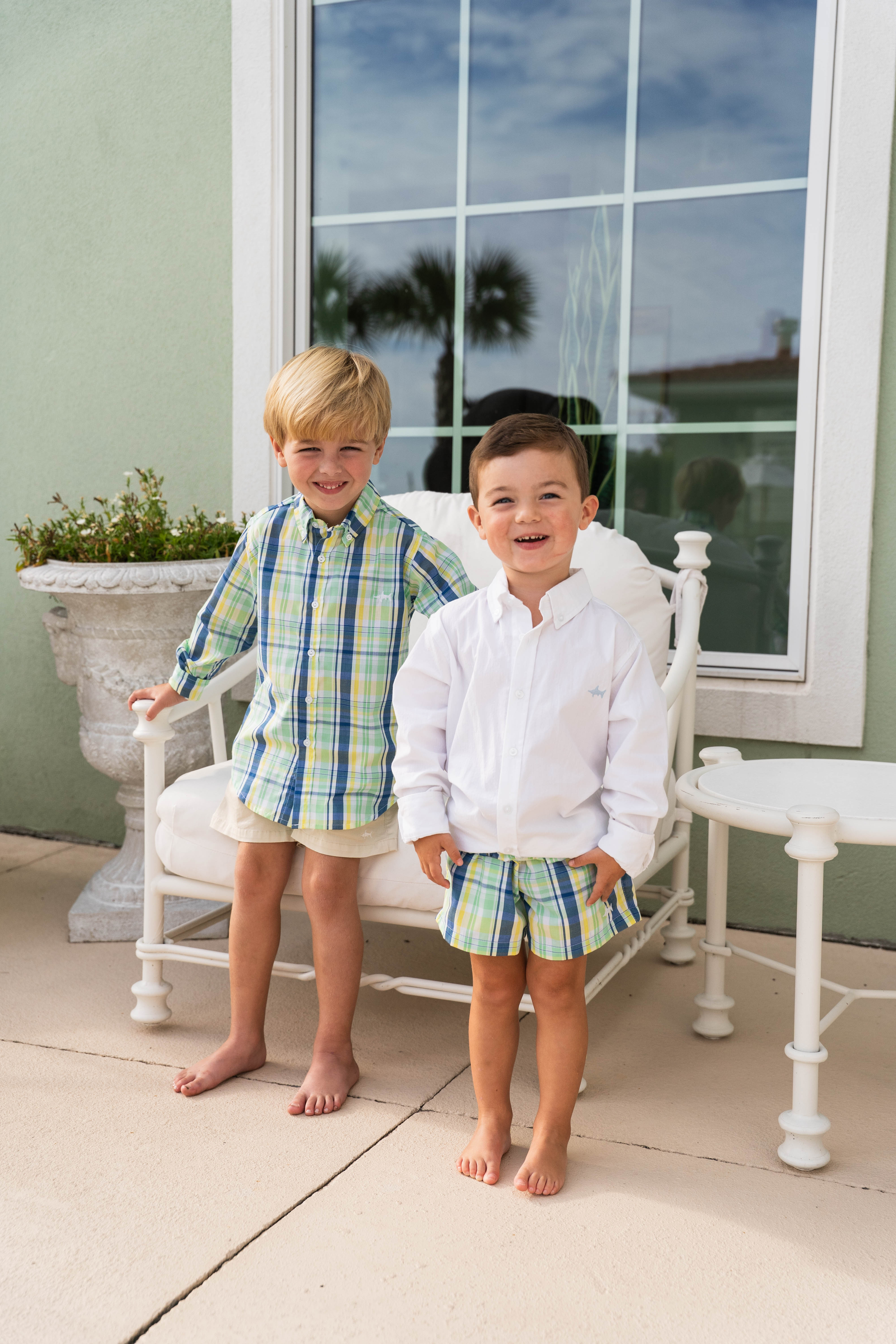 brother matching outfits. two boys sitting on a blanket in matching outfits.