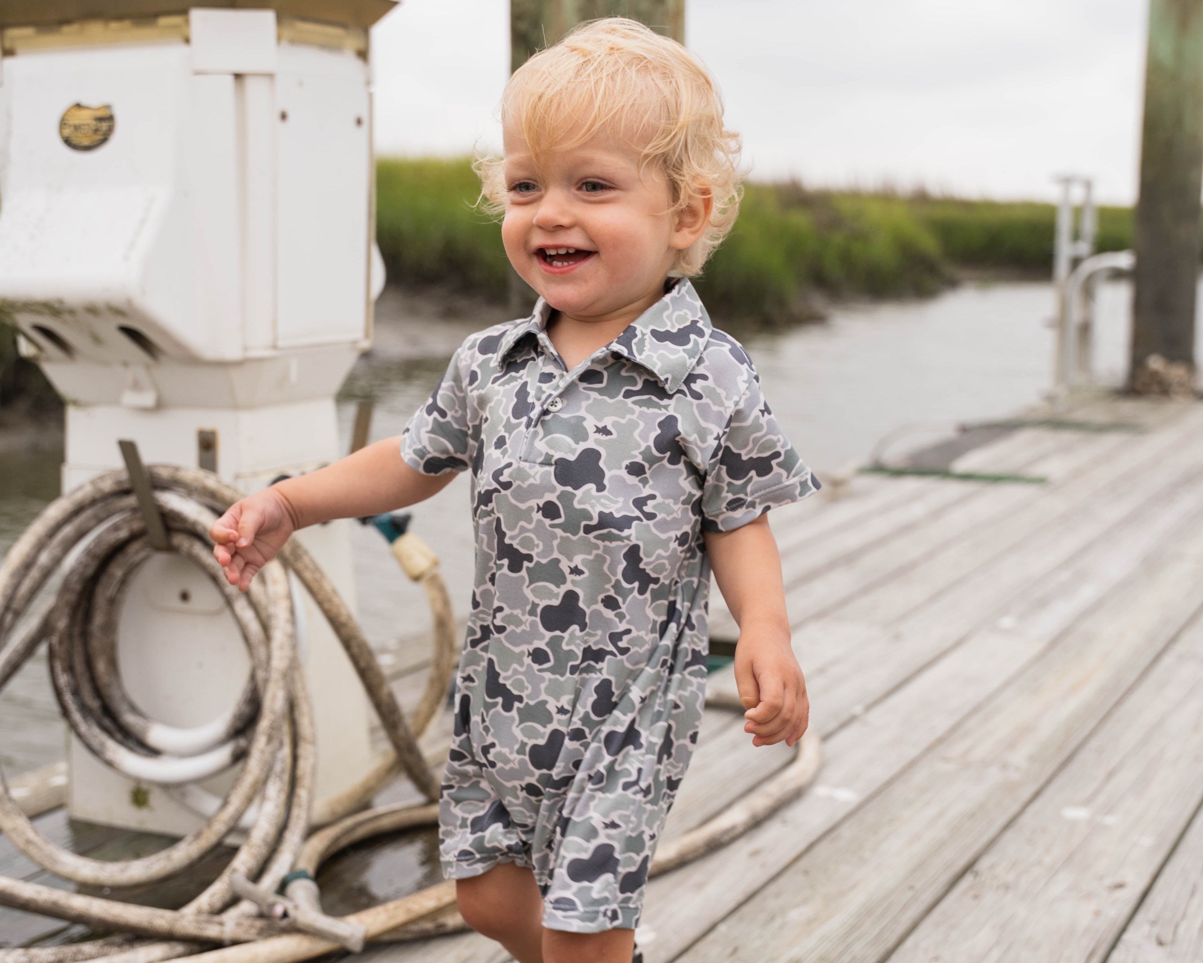 brother matching outfits. two boys sitting on a blanket in matching outfits.